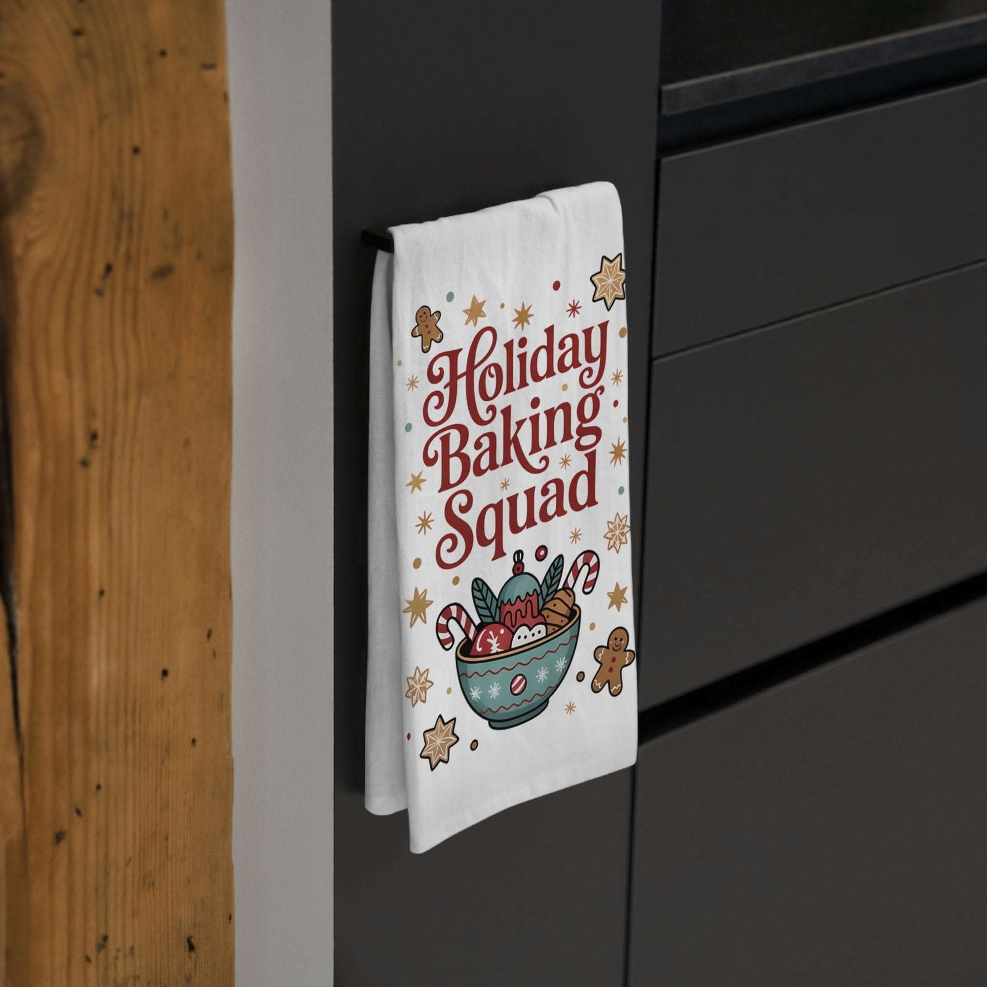 White cotton tea towel featuring 'Holiday Baking Squad' design, measuring 28\" × 28\" from Printify.
