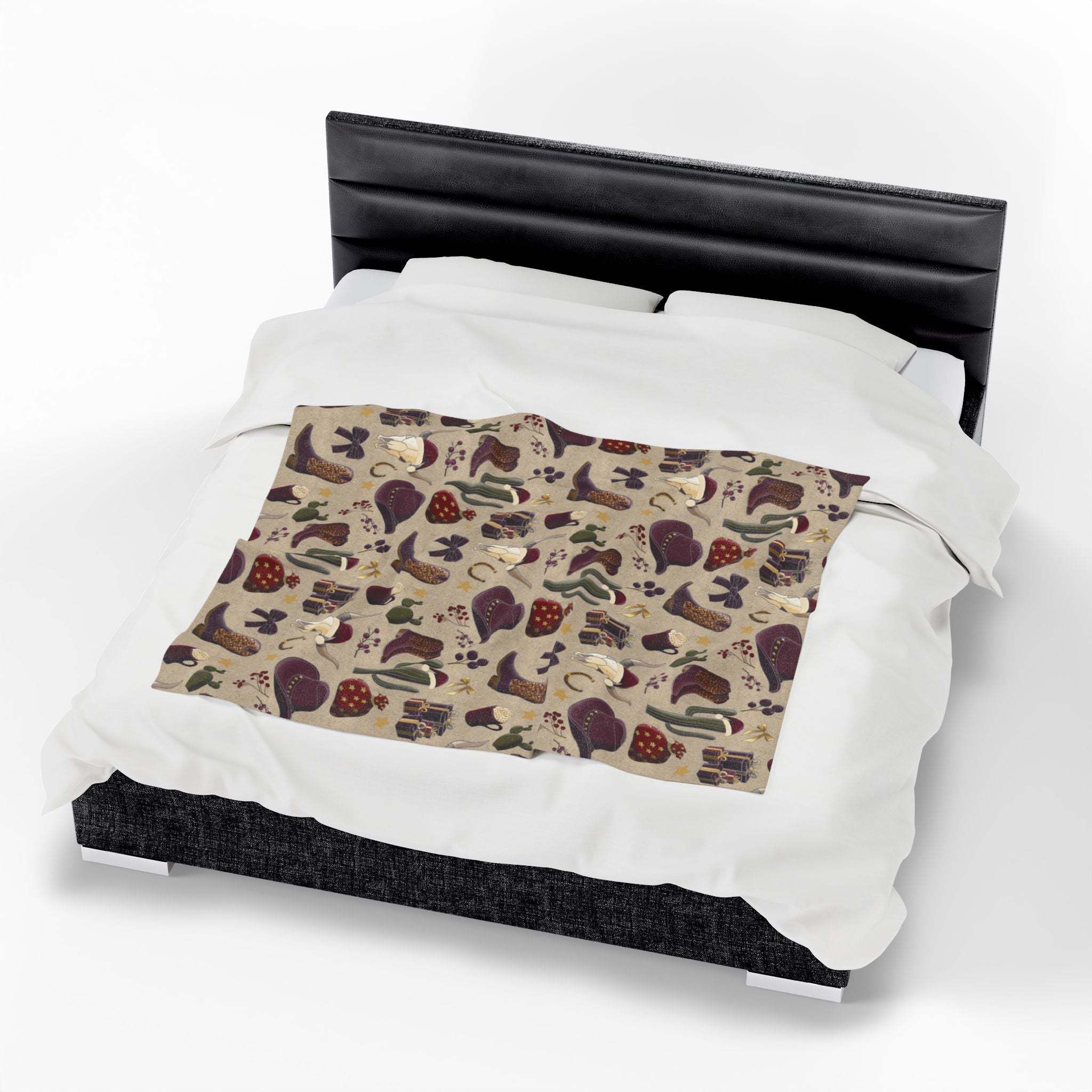 Cowboy Christmas design plush blanket on bed with festive holiday motifs