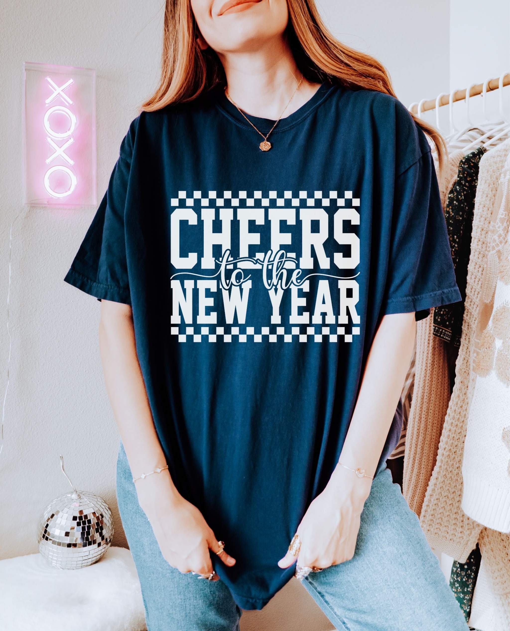 Woman wearing navy Cheers for the New Year T-Shirt with white text and vintage style