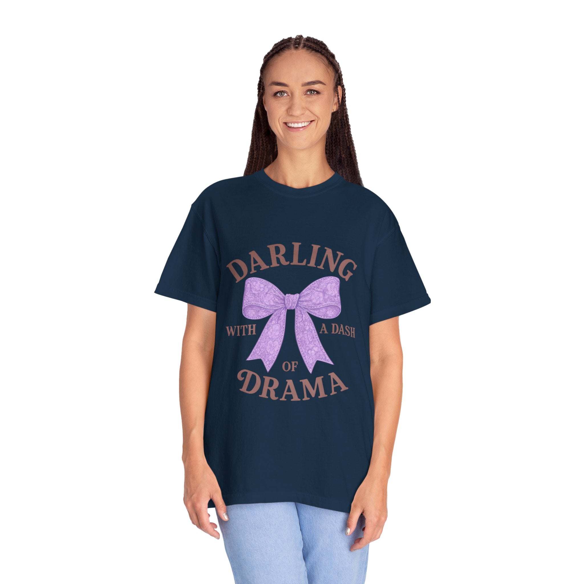 Woman wearing navy Darling With a Dash of Drama T-shirt with purple bow graphic and text.