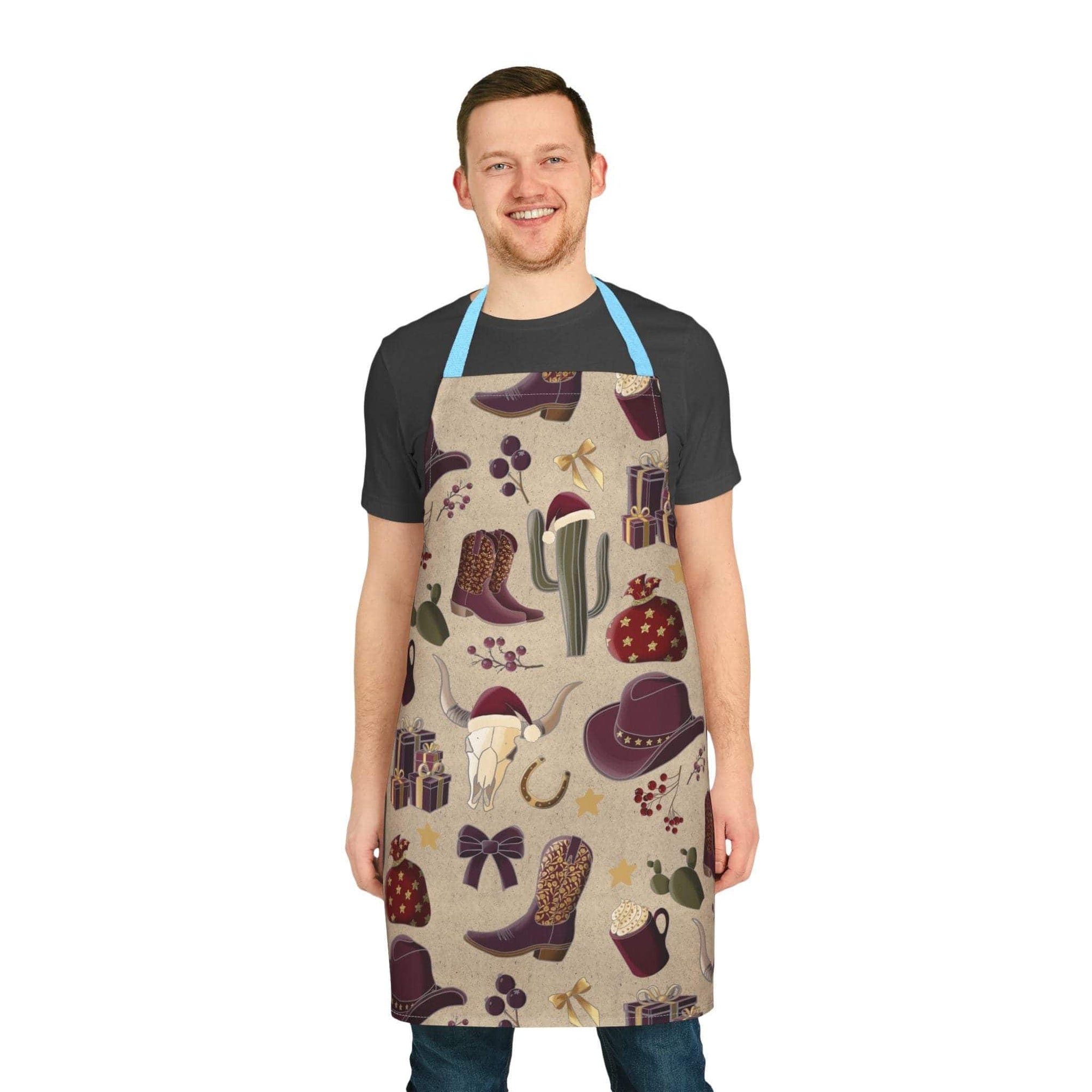 Man wearing cowboy Christmas apron with festive western holiday prints including boots, cactus, hat, gifts, and skull design