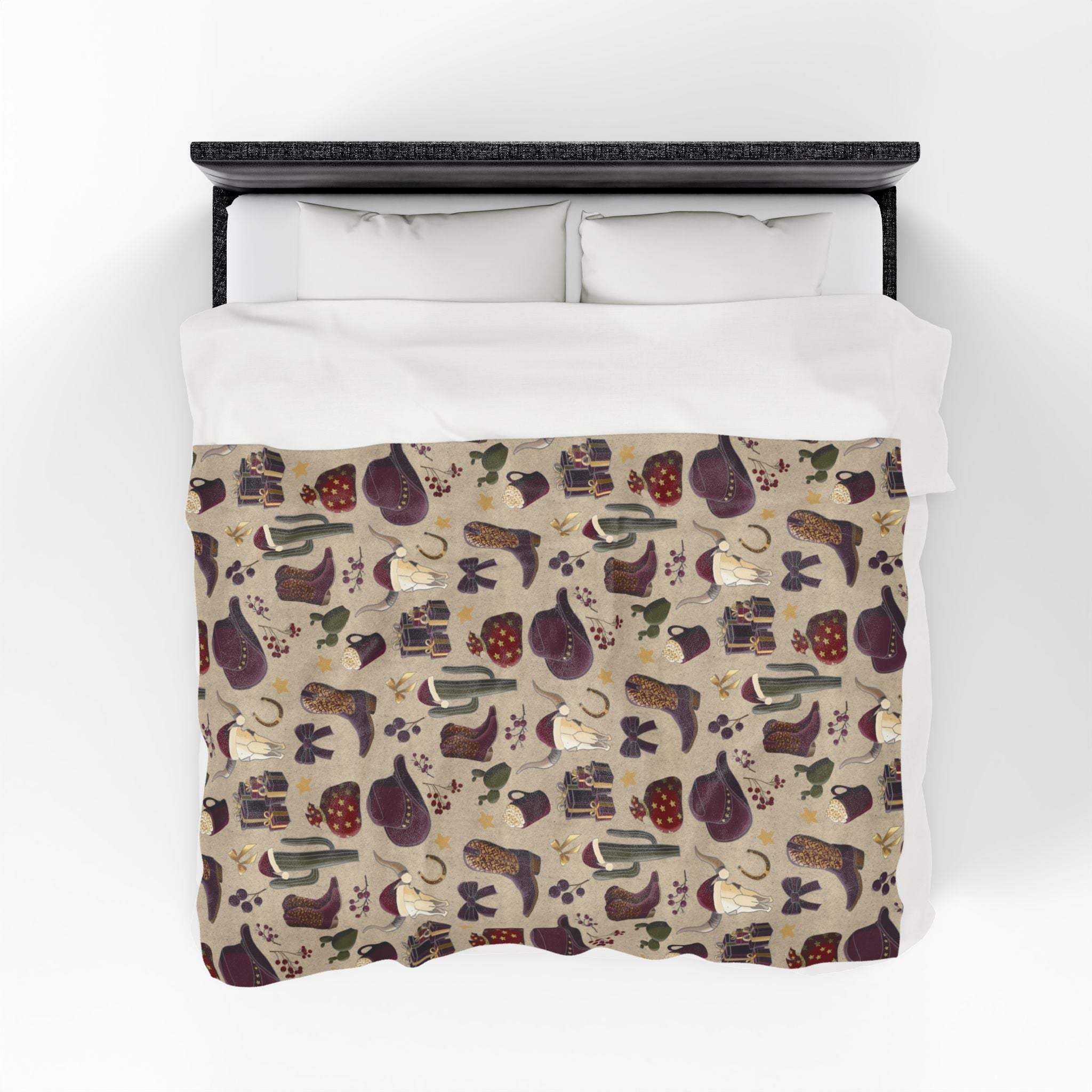 Cowboy Christmas themed plush blanket with festive Western pattern on bed