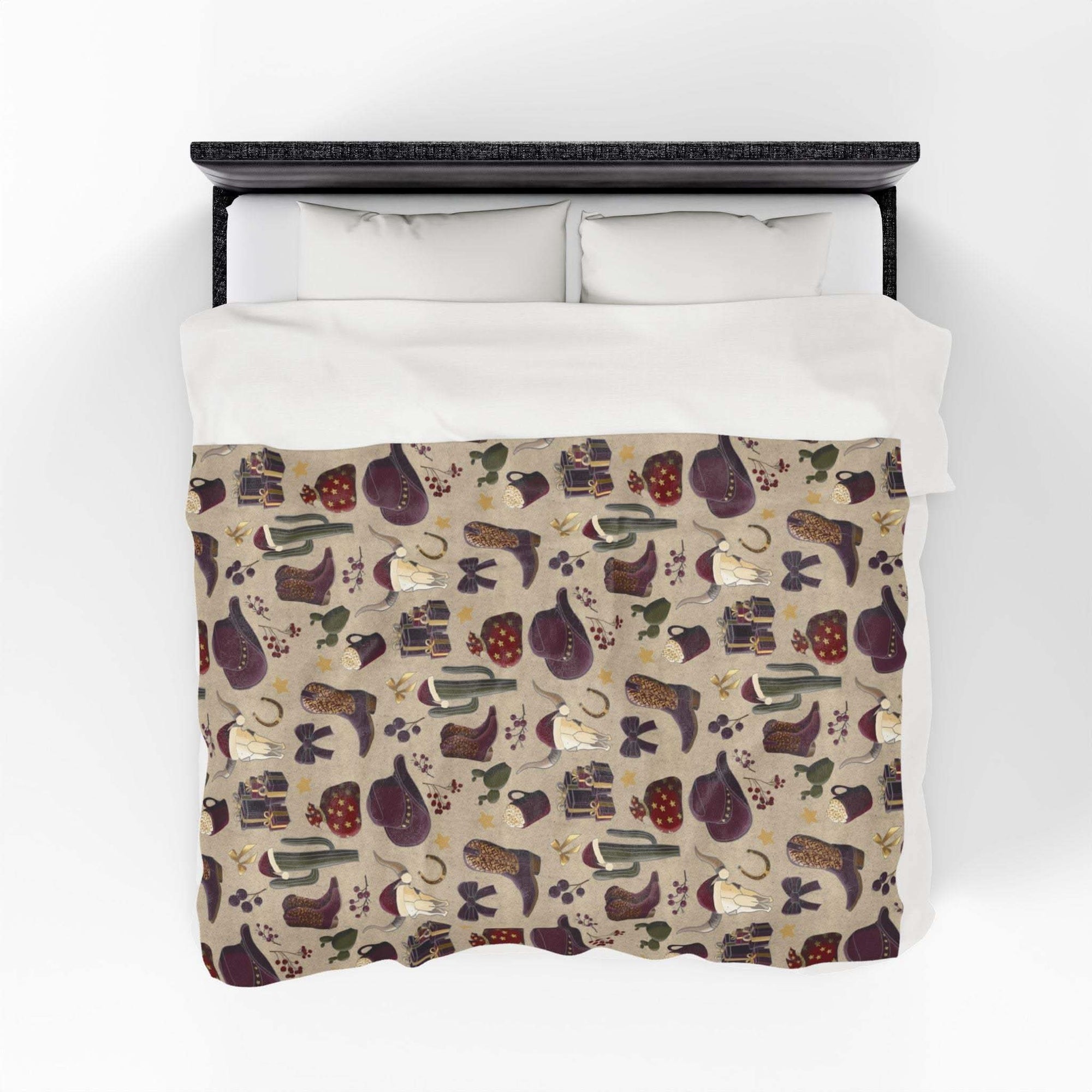 Cowboy Christmas themed plush blanket with festive Western pattern on bed