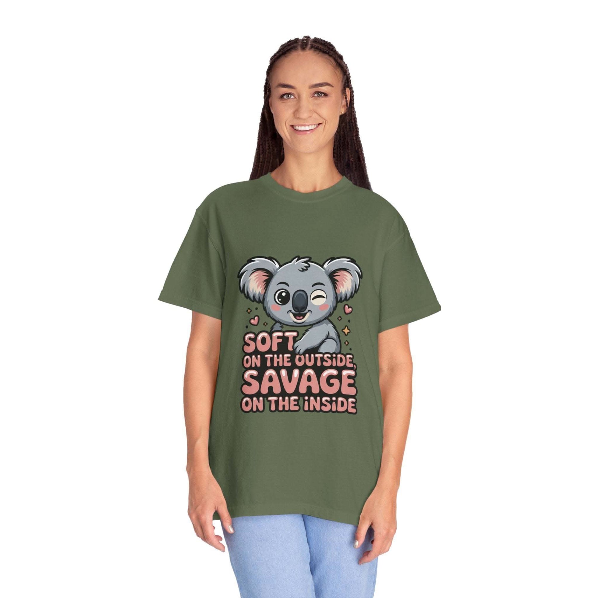 Woman wearing green koala graphic t-shirt with "Soft on the Outside, Savage on the Inside" text