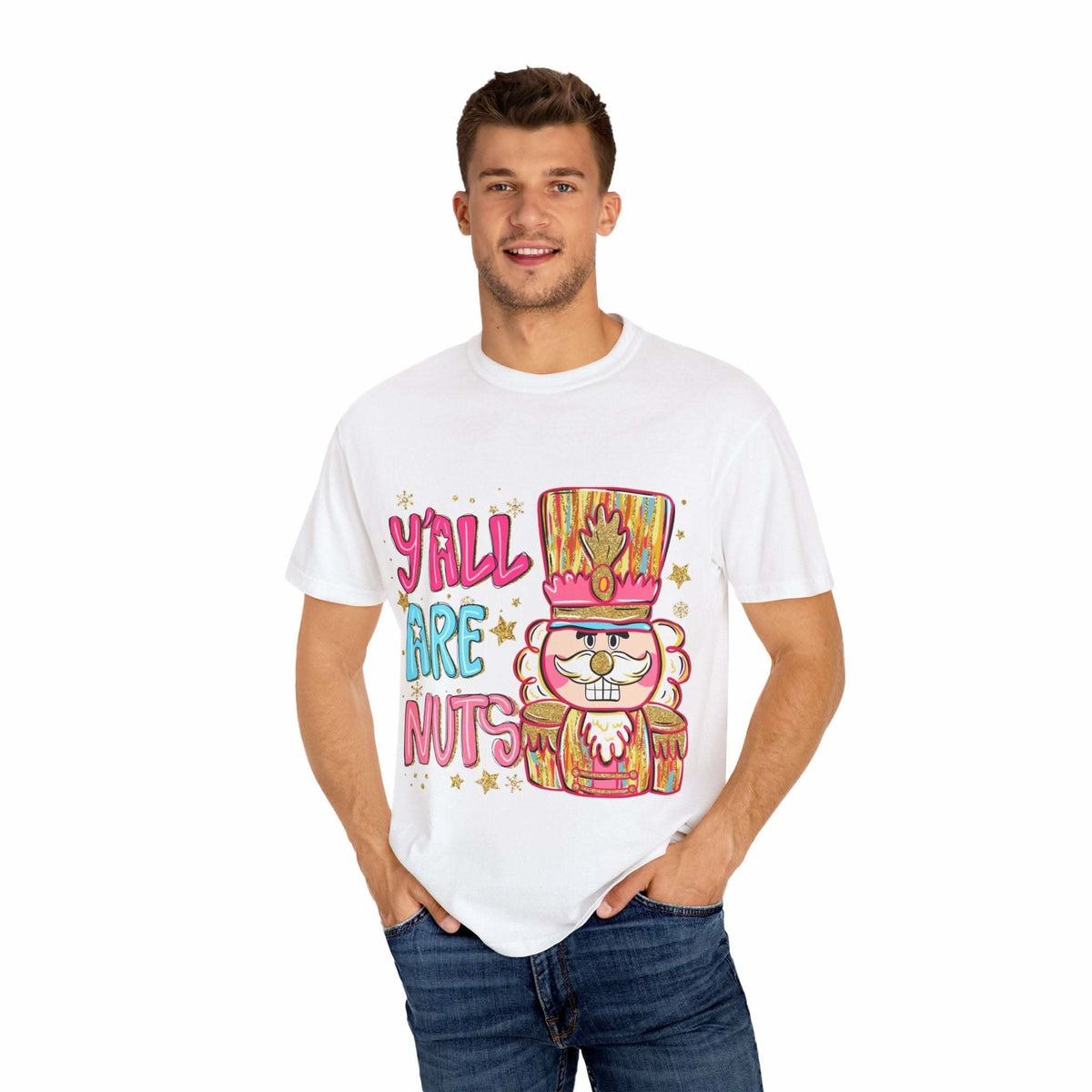 Man wearing white Yall Are Nuts Nutcracker graphic T-shirt with colorful nutcracker design and festive text