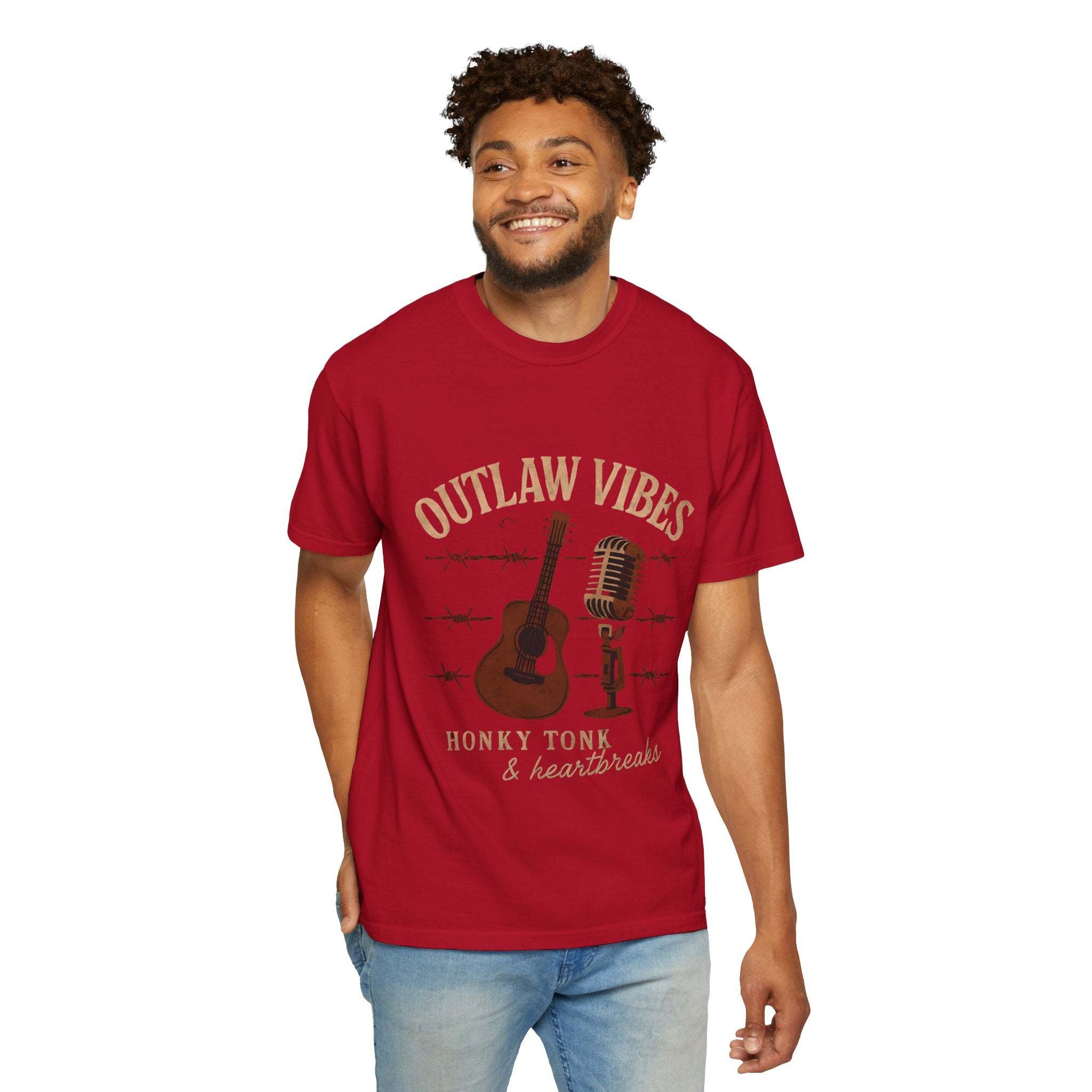 Man wearing a red t-shirt with 'Outlaw Vibes' graphic design on a white background