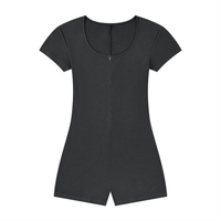 Woman wearing a women's ribbed tie-waist cape romper with a fitted Y2K athleisure style and scoop neckline