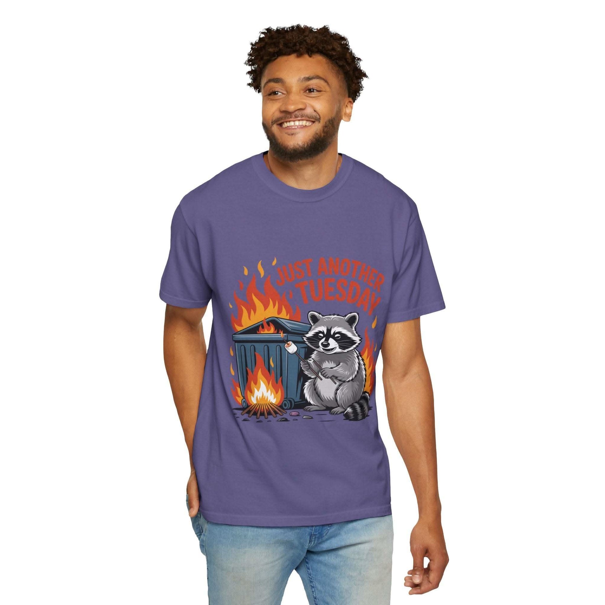 Man wearing a purple t-shirt with a raccoon graphic and text on a white background