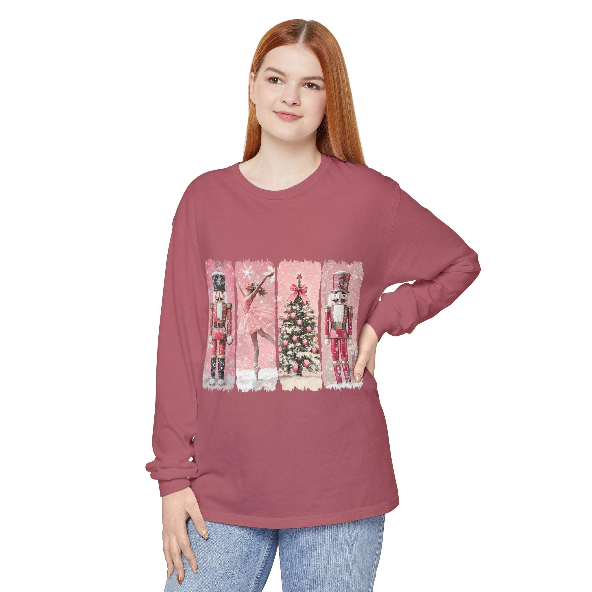 Woman wearing preppy pink long sleeve t-shirt with watercolor Nutcracker Christmas design