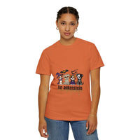 Woman wearing an orange Puppies Halloween T-shirt with puppies in Halloween costumes printed on front