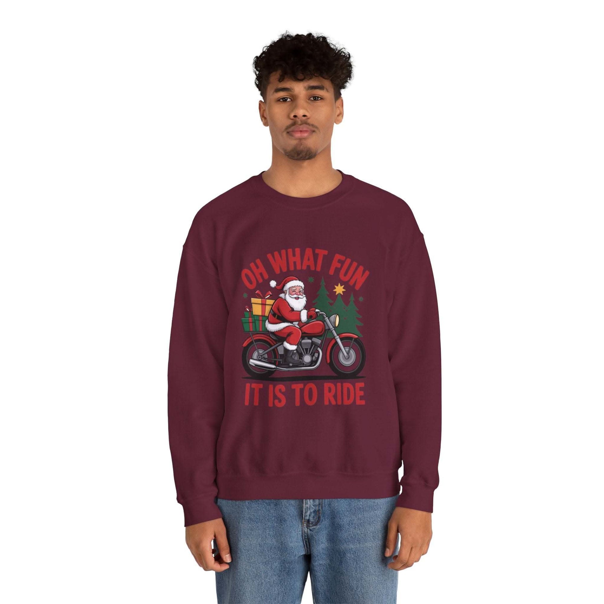 Man wearing navy Motorcycle Santa Sweatshirt with Santa on motorcycle and holiday gifts design in festive setting