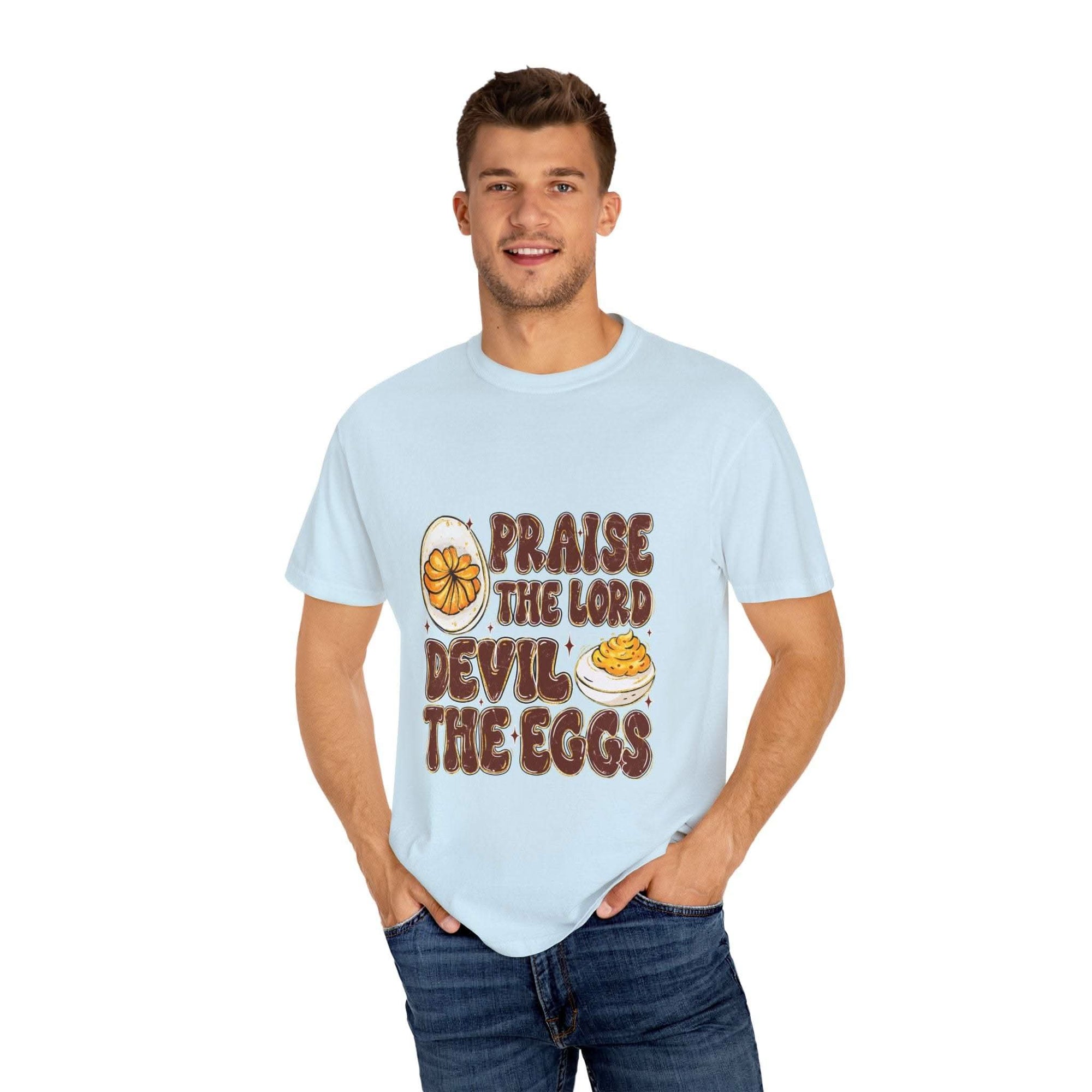 White cotton t-shirt featuring 'Praise the Lord, Devil the Eggs' design, perfect for Easter and Christian apparel.