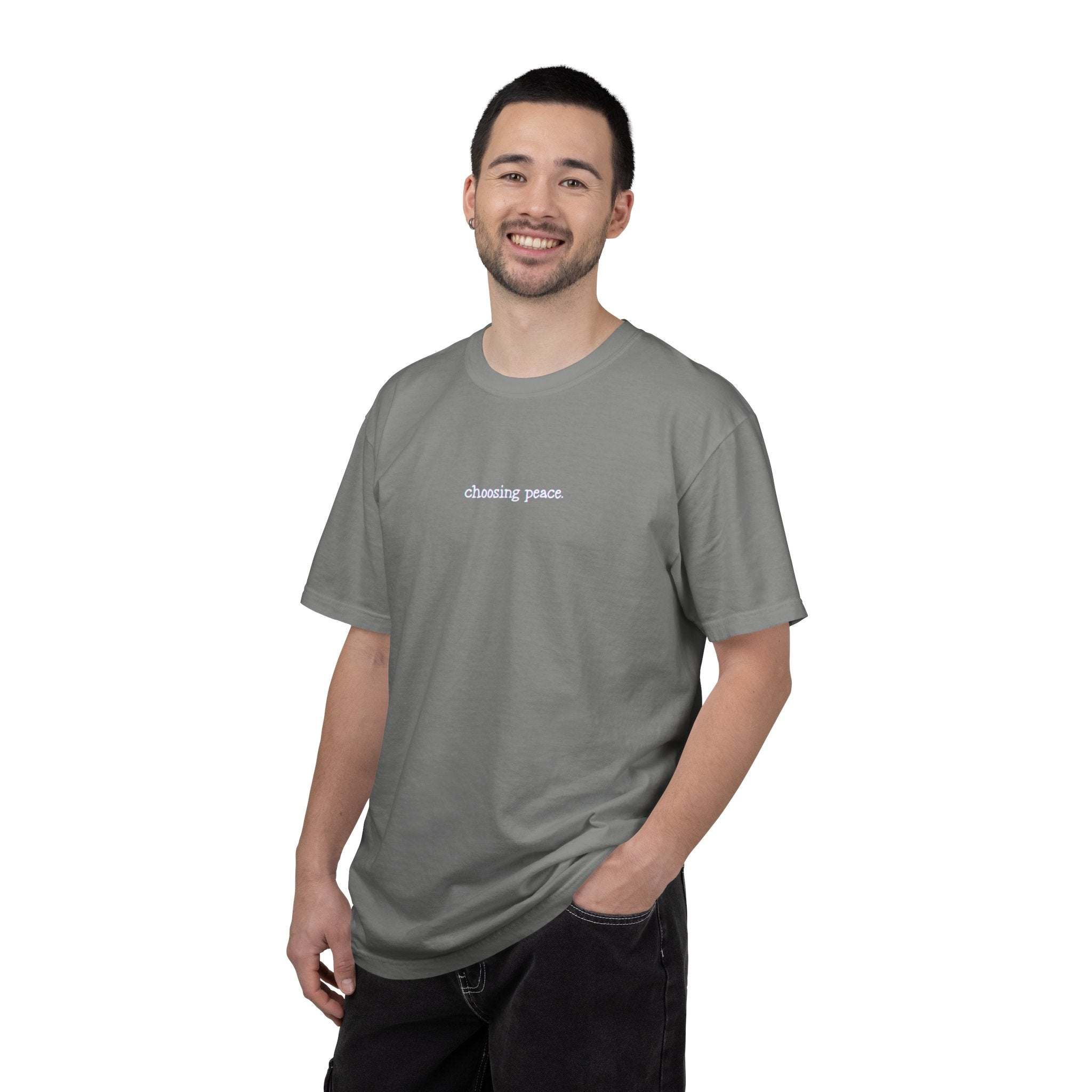 Man wearing a gray t-shirt with text on a white background