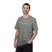 Man wearing a gray t-shirt with text on a white background
