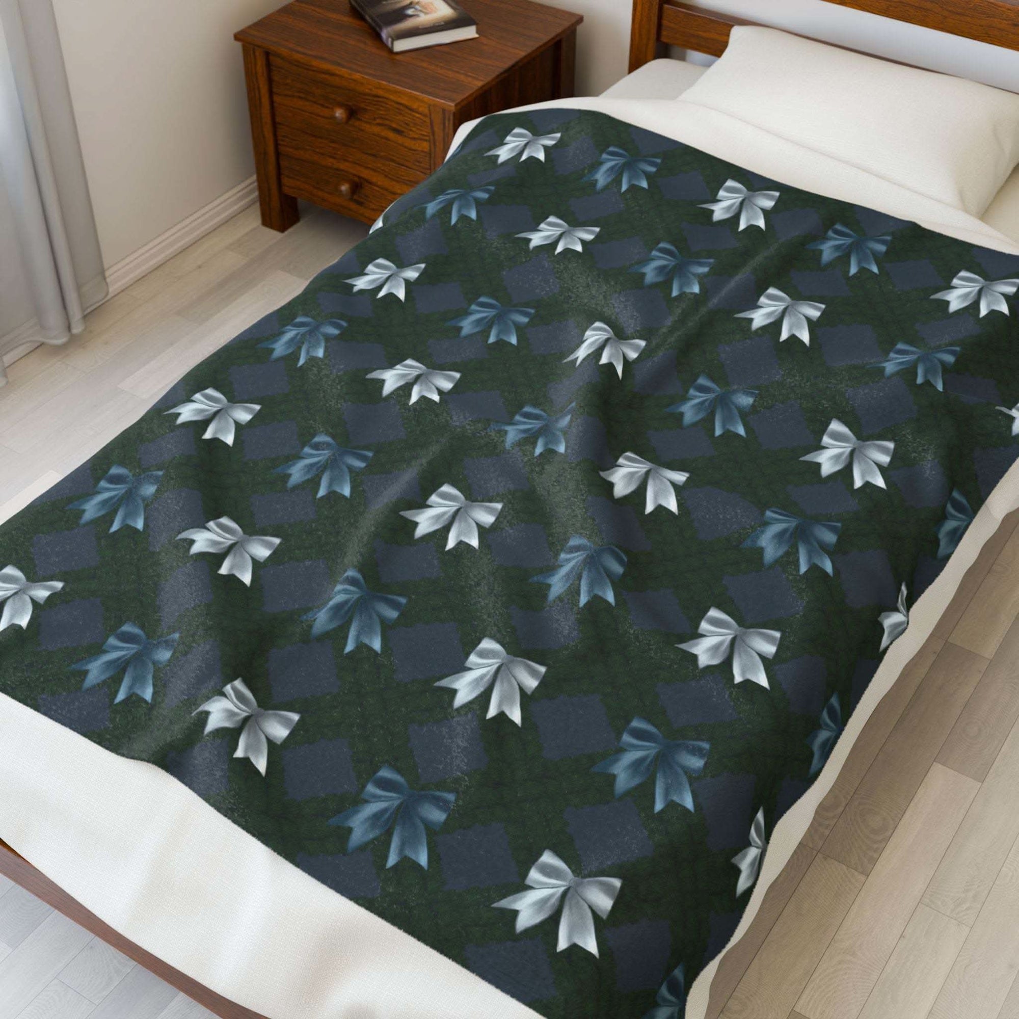 Velveteen plush blanket with winter coquette bows design on bed in cozy bedroom