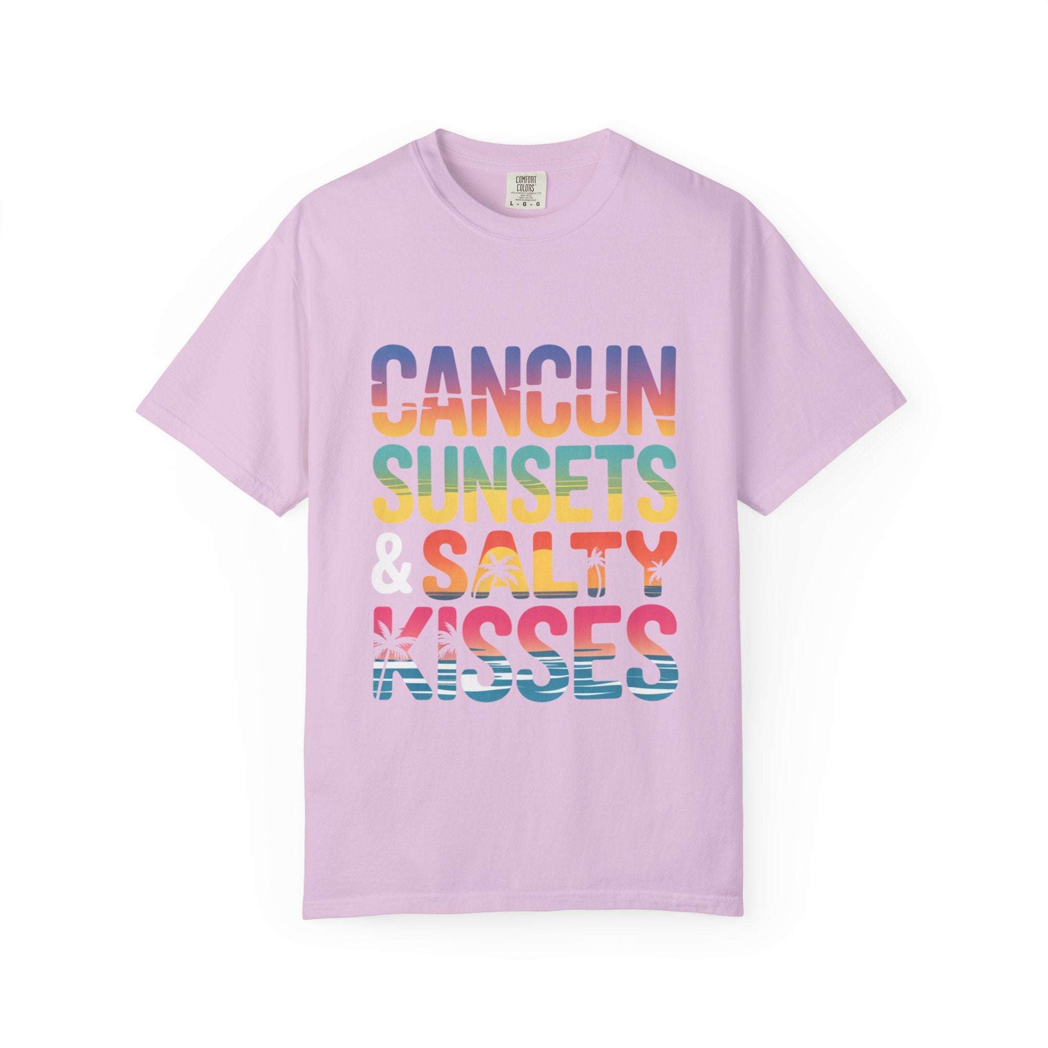 Pink t-shirt with colorful text 'Cancun Sunsets & Salty Kisses' on a white background