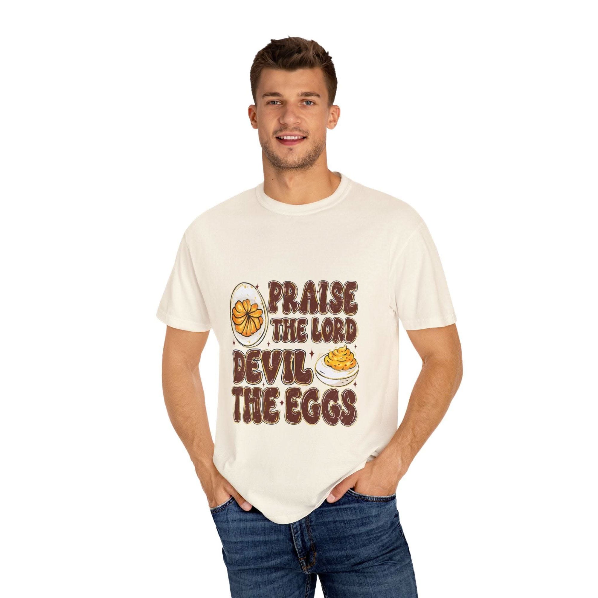 White cotton t-shirt featuring 'Praise the Lord, Devil the Eggs' design, perfect for Easter and Christian apparel.