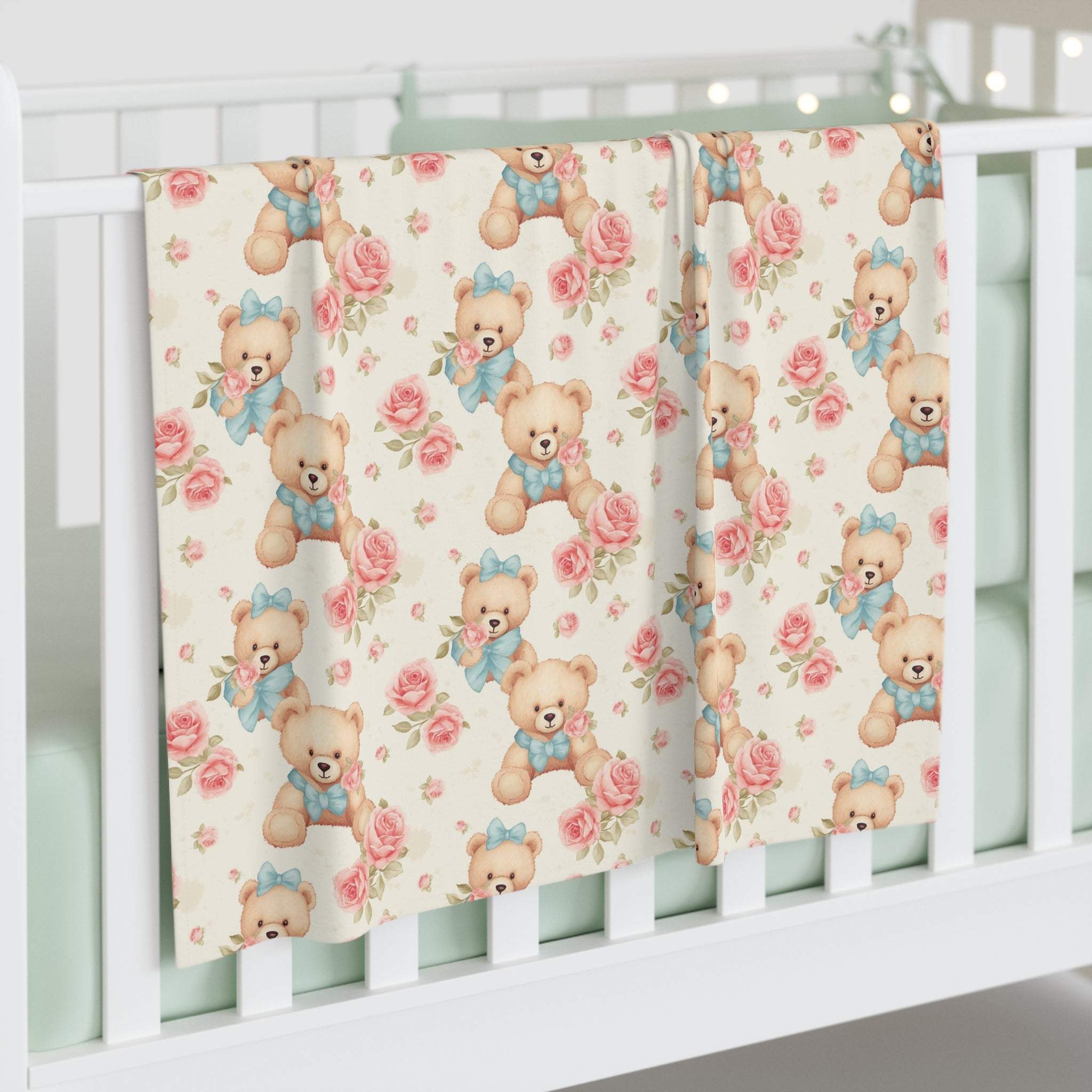Floral teddy bear swaddle blanket hanging on white crib rail, soft 100% jersey polyester fabric