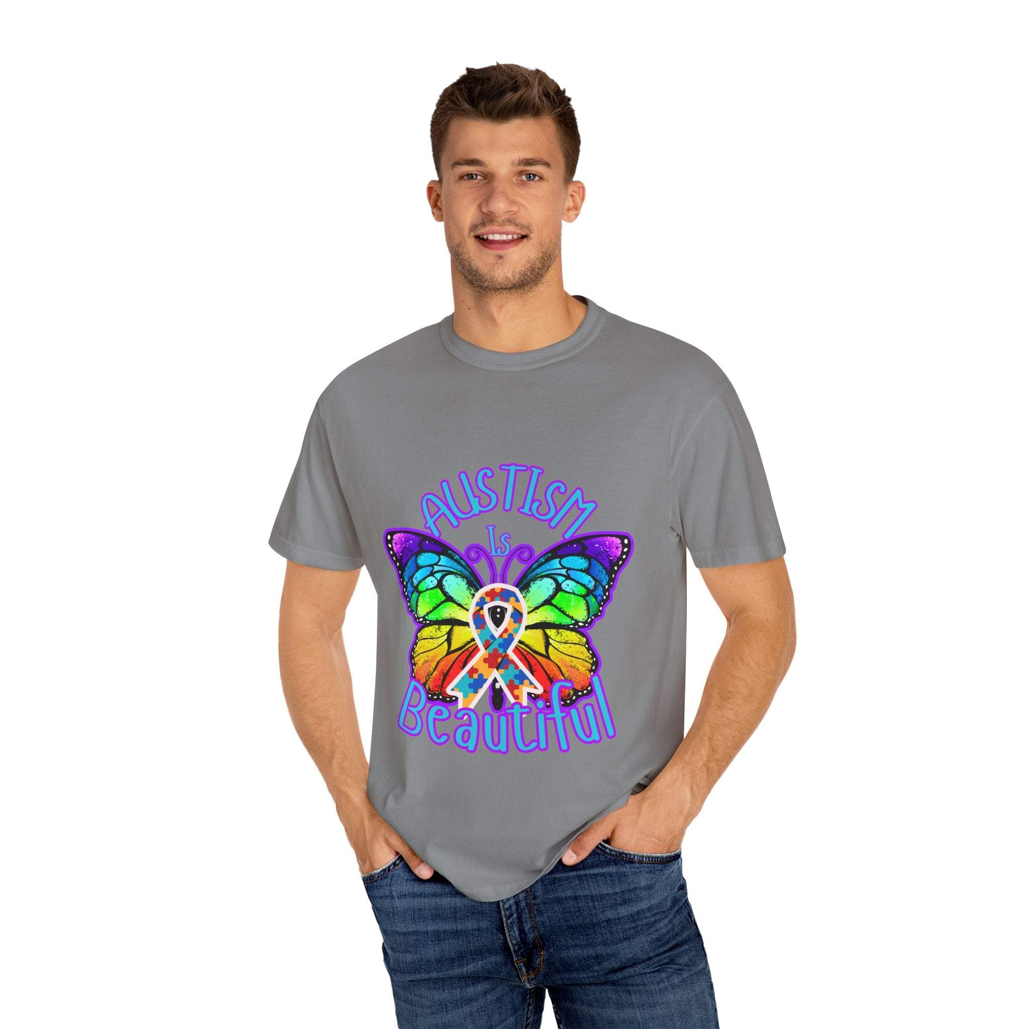 Man wearing gray Autism is Beautiful T-shirt with colorful butterfly and ribbon design promoting autism awareness and acceptance