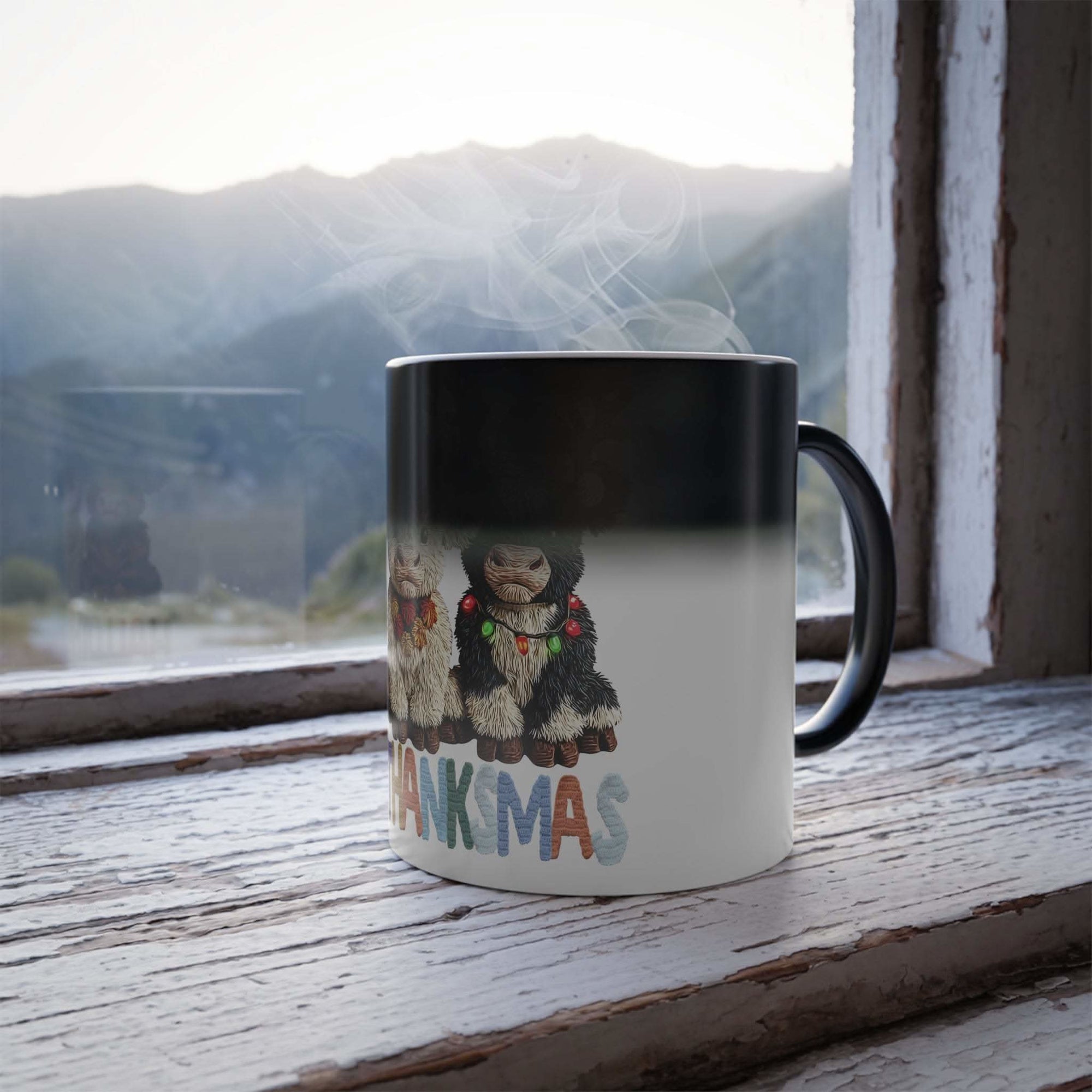 Mug with Christmas-themed design featuring two bears and 'Thankmas' text, placed on a wooden surface with a mountain view.