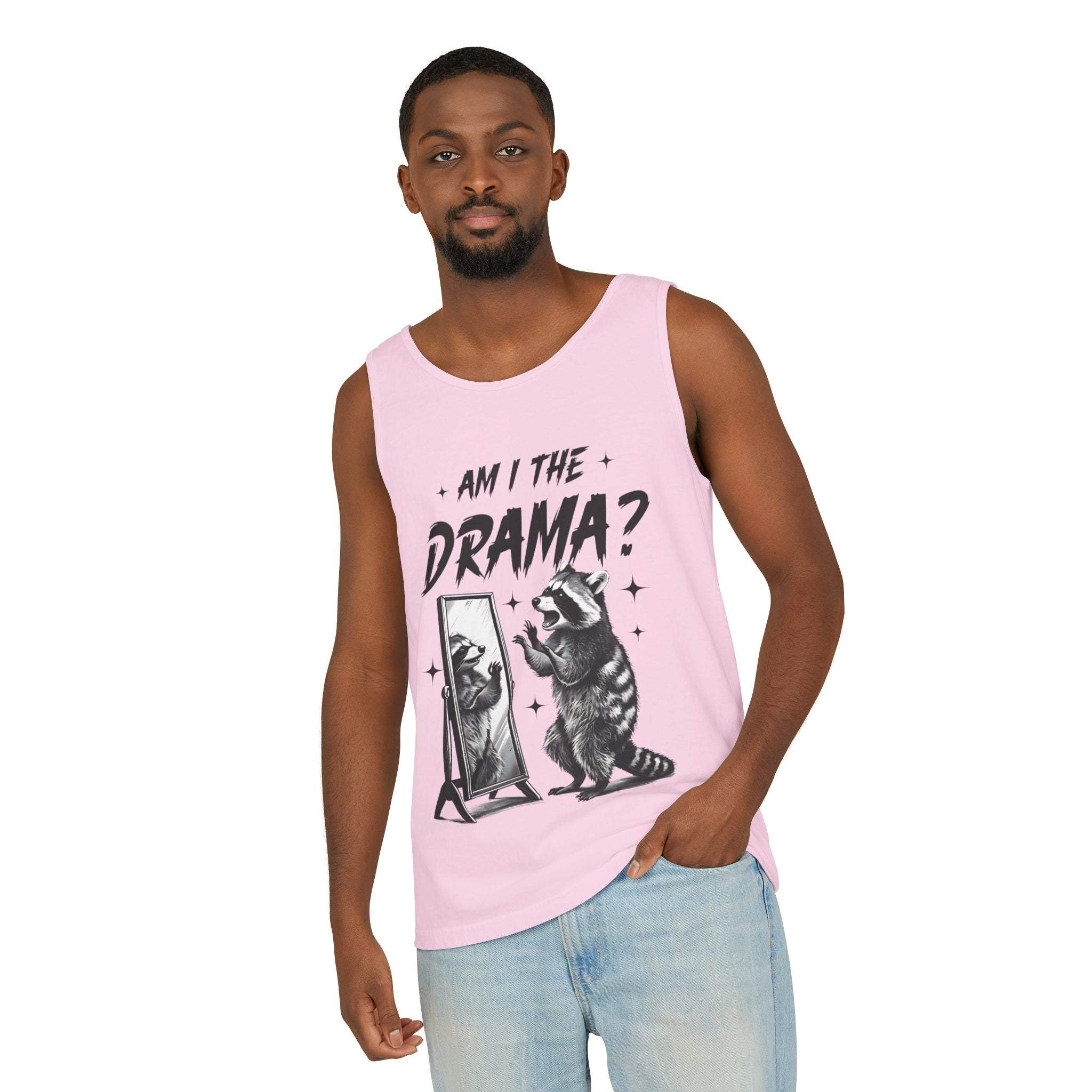 Man wearing pink tank top with "Am I The Drama?" text and raccoon graphic looking in mirror