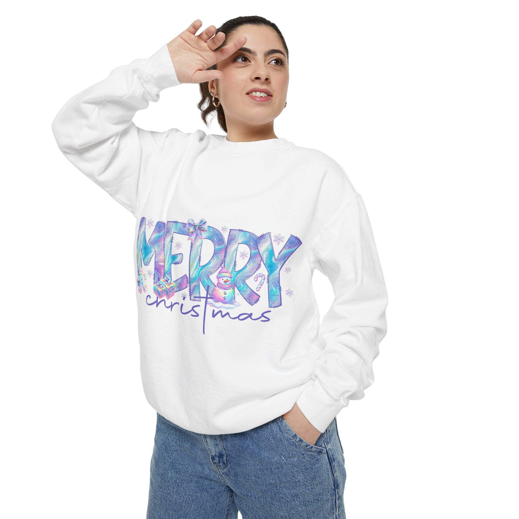 Woman wearing white sweatshirt with iridescent Merry Christmas design and blue jeans