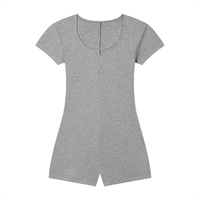 Woman wearing a ribbed tie-waist cape romper with a skinny fit and scoop neckline in a casual Y2K athleisure style