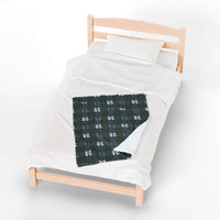 Velveteen plush blanket with winter coquette bows pattern on bed