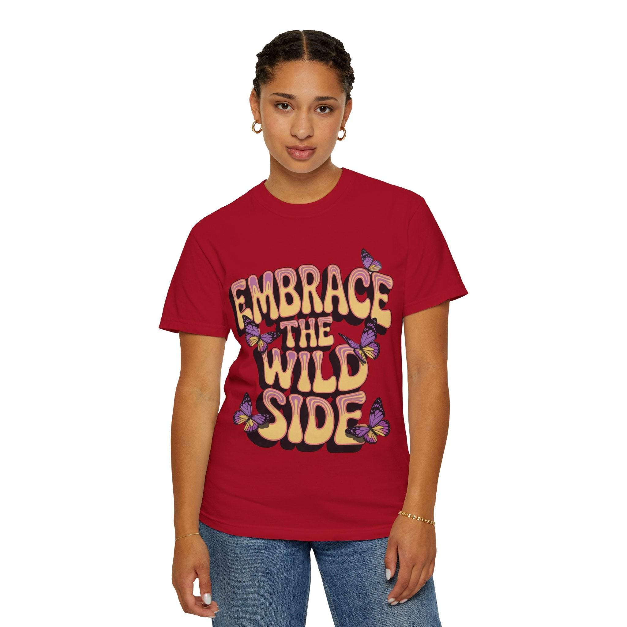 Unisex garment-dyed T-shirt in red with "Embrace the Wild Side" print and butterfly design, made of soft 100% ring-spun cotton.