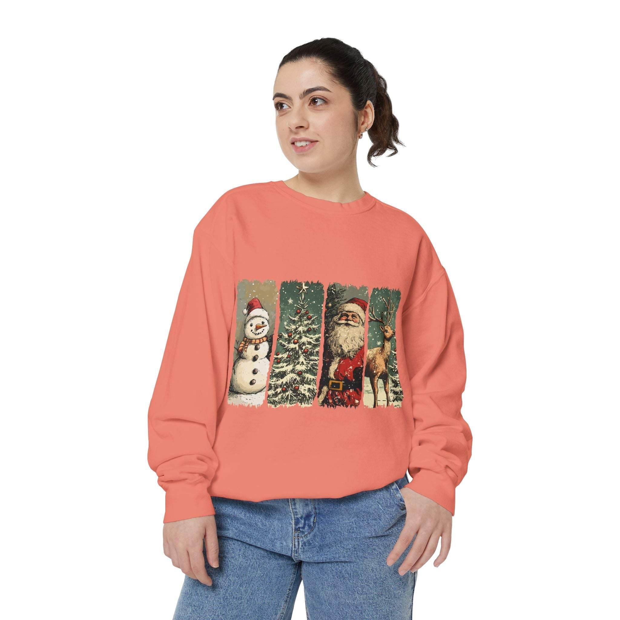 Woman wearing vintage Christmas sweatshirt with watercolor swatches of snowman, tree, Santa, and reindeer on coral background