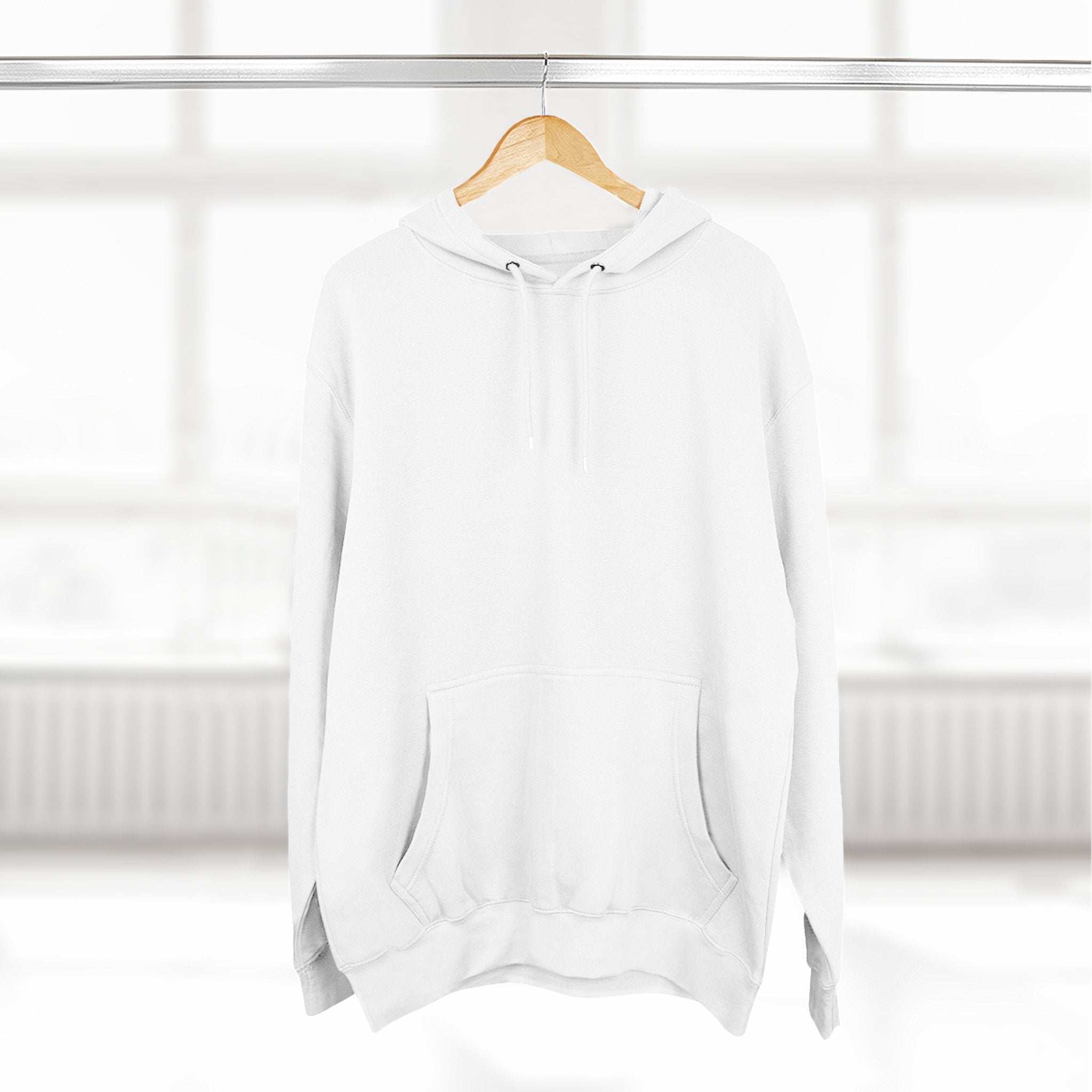 White fleece hoodie with adjustable hood and front pocket hanging on wooden hanger