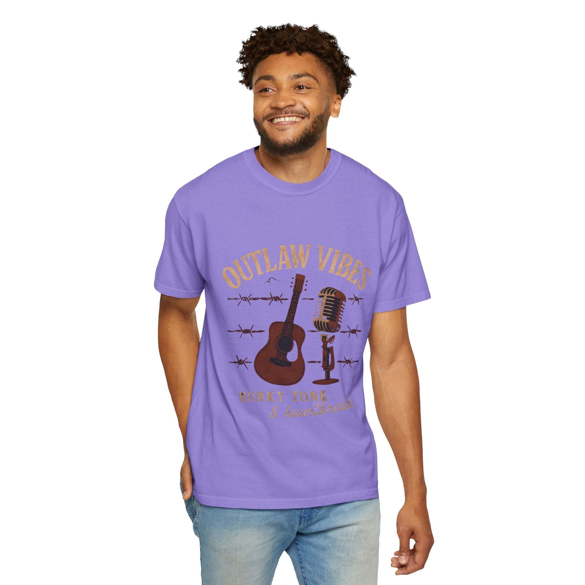 Man wearing a purple t-shirt with 'Outlaw Vibes' graphic design on a white background