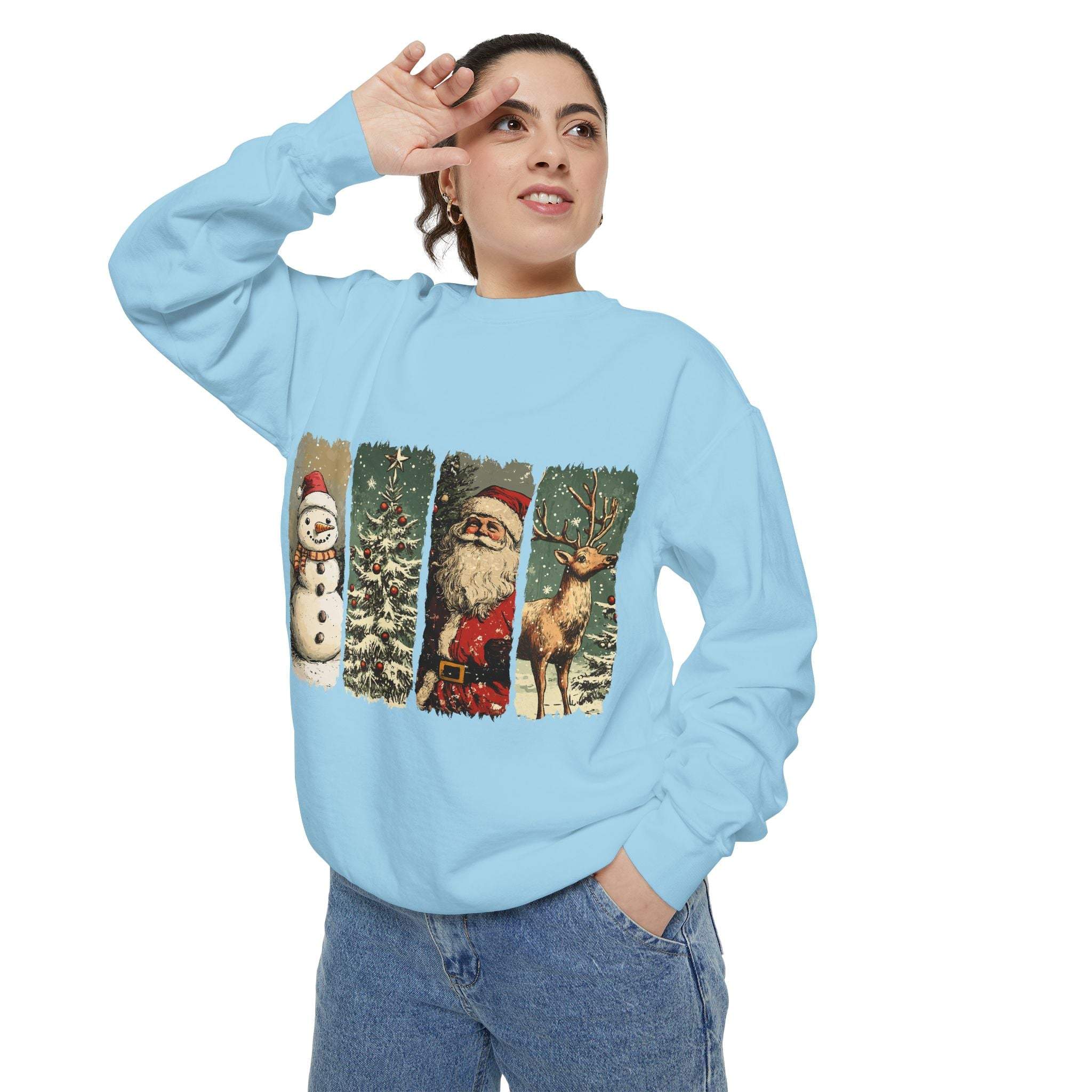 Woman wearing vintage Christmas sweatshirt with watercolor swatches of snowman, tree, Santa, and reindeer on light blue fabric