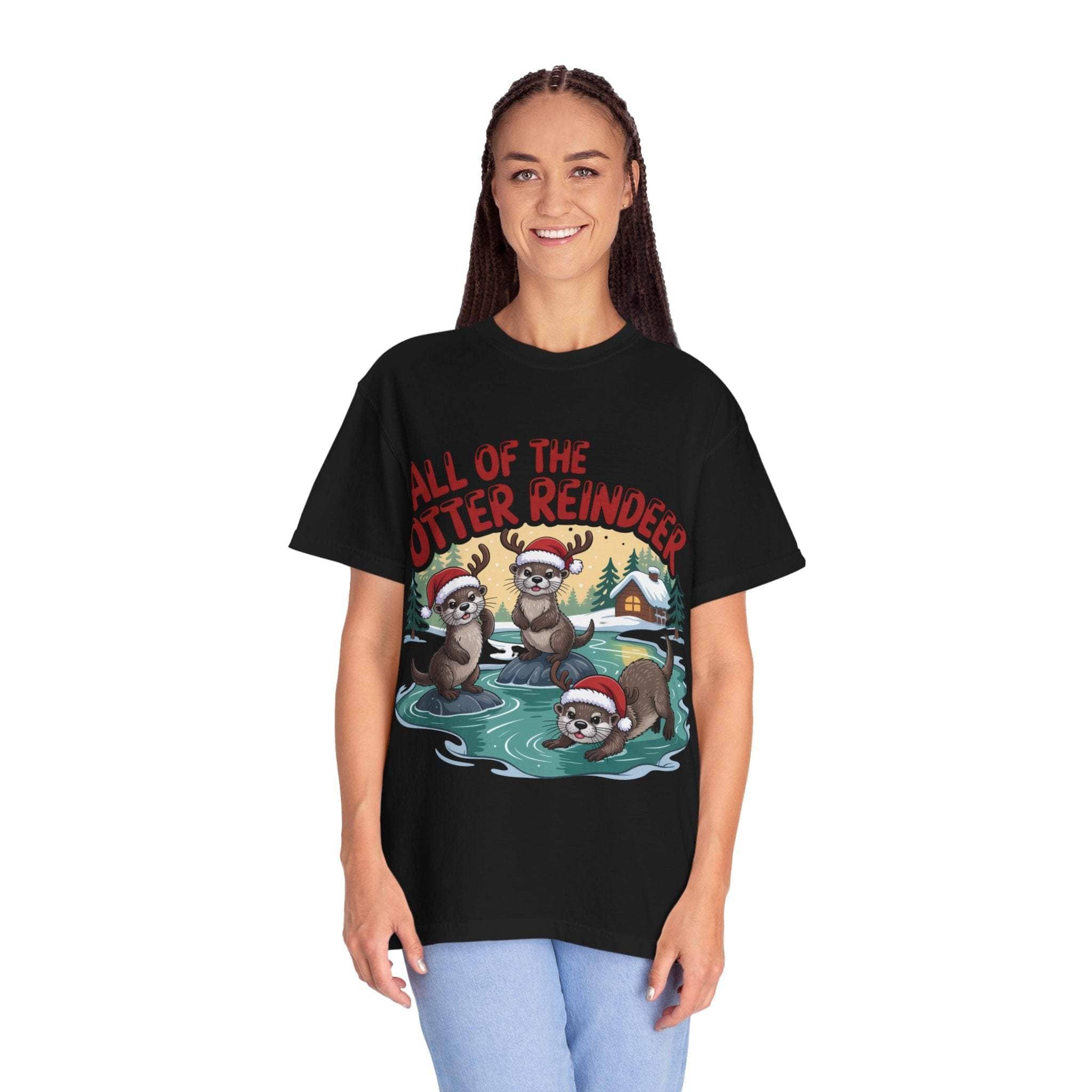 Woman wearing black Otter Reindeer Tee with festive cartoon otters in Santa hats on holiday background