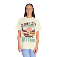 Woman wearing vintage style Country Lovin Girl T-shirt with rural sunset and horse graphic