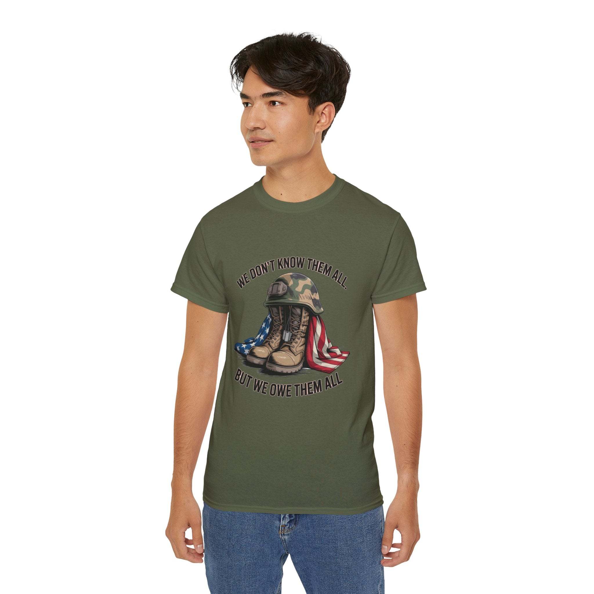 Unisex veteran T-shirt with "We Don’t Know Them All But We Owe Them All" message and boot graphic in olive green
