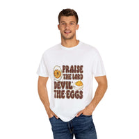 Religious unisex T-shirt with "Praise the Lord, Devil the Eggs" humorous design on white cotton fabric