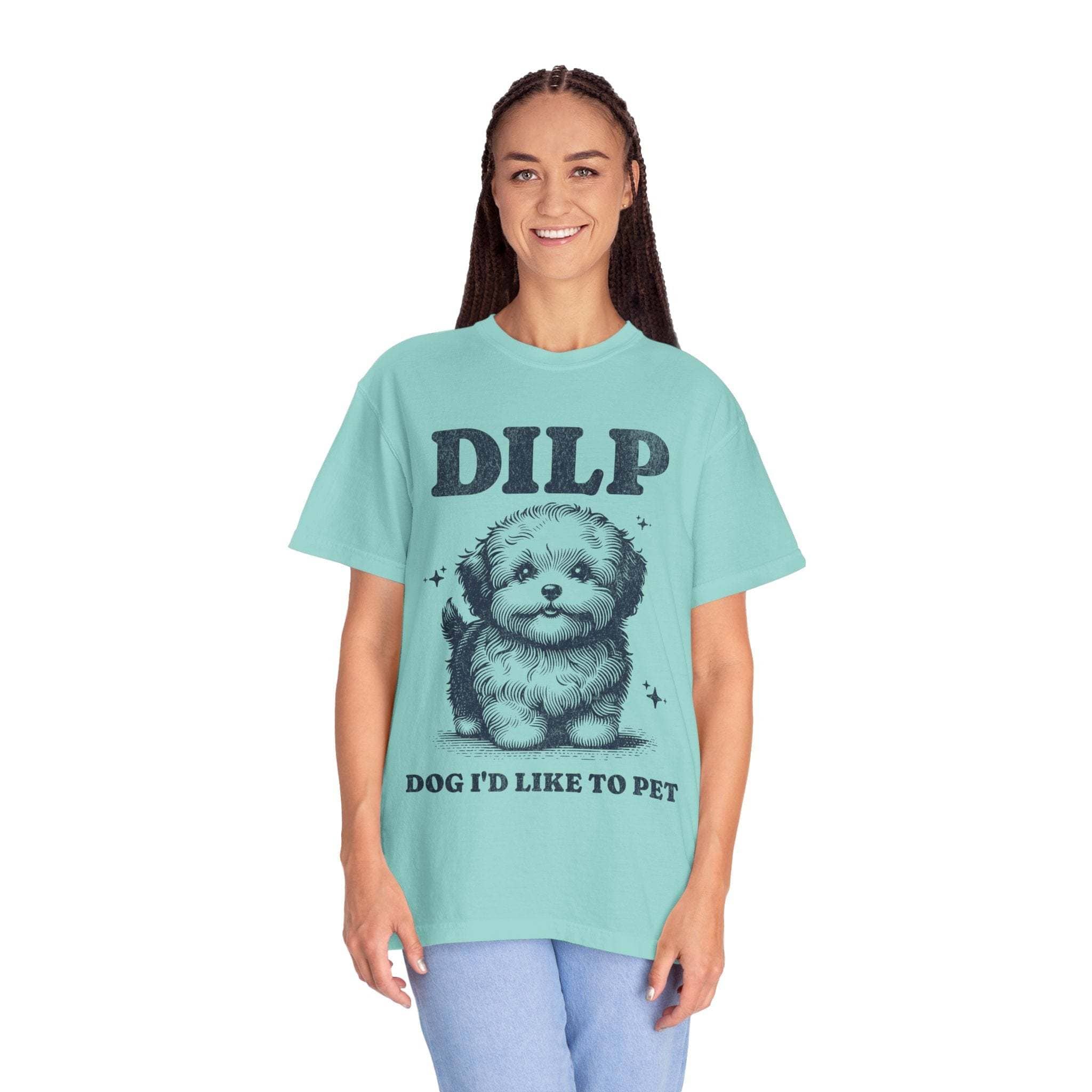 Woman wearing a light blue garment-dyed T-shirt with playful DILP dog graphic and text "Dog I'd Like to Pet"