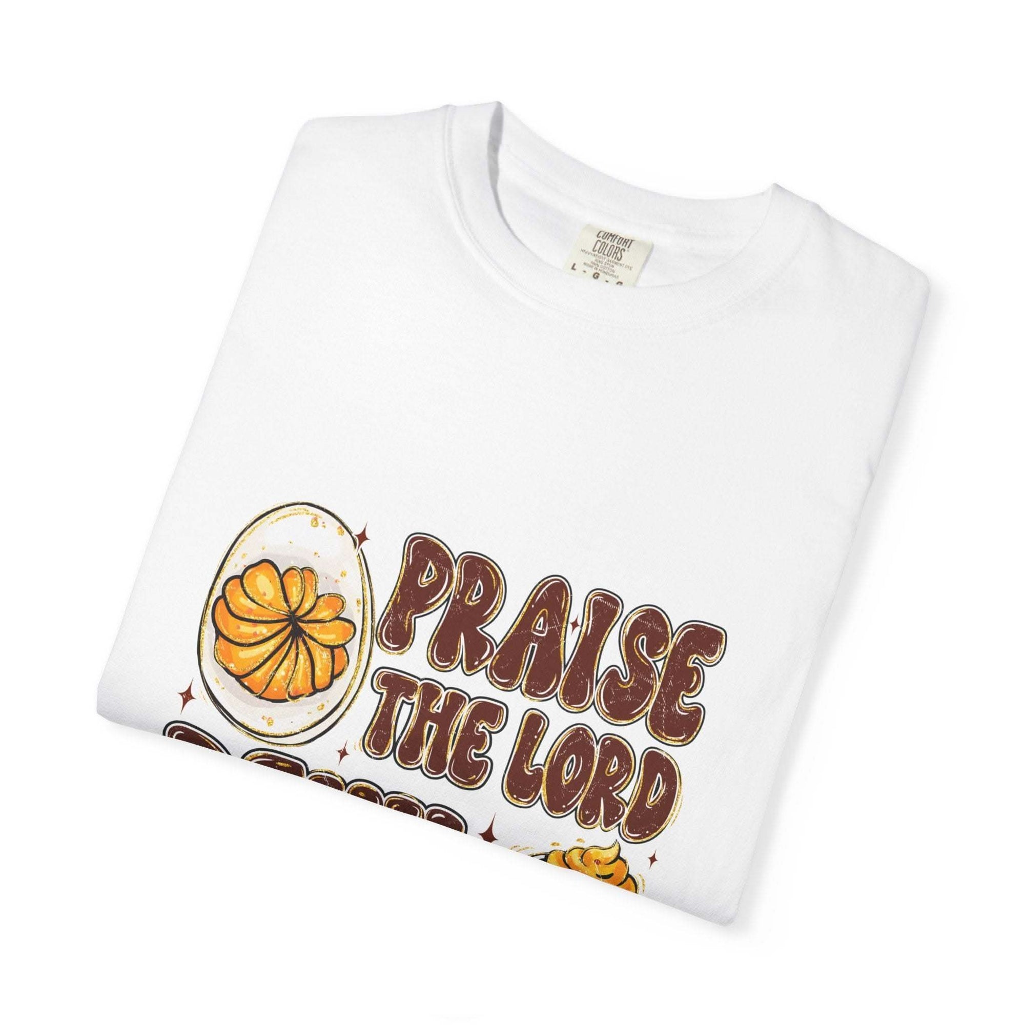 White cotton t-shirt featuring 'Praise the Lord, Devil the Eggs' design, perfect for Easter and Christian apparel.