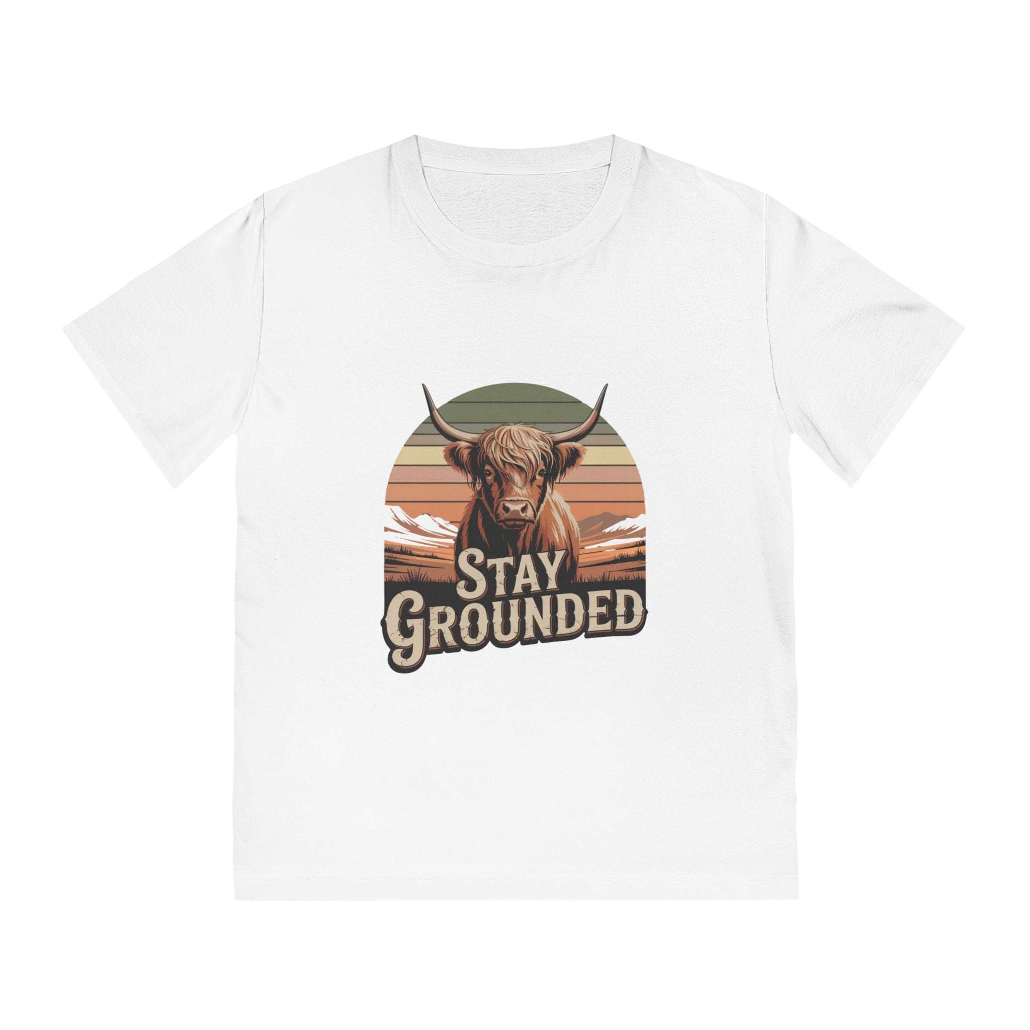 White t-shirt with a graphic of a highland cow and 'Stay Grounded' text on a white background