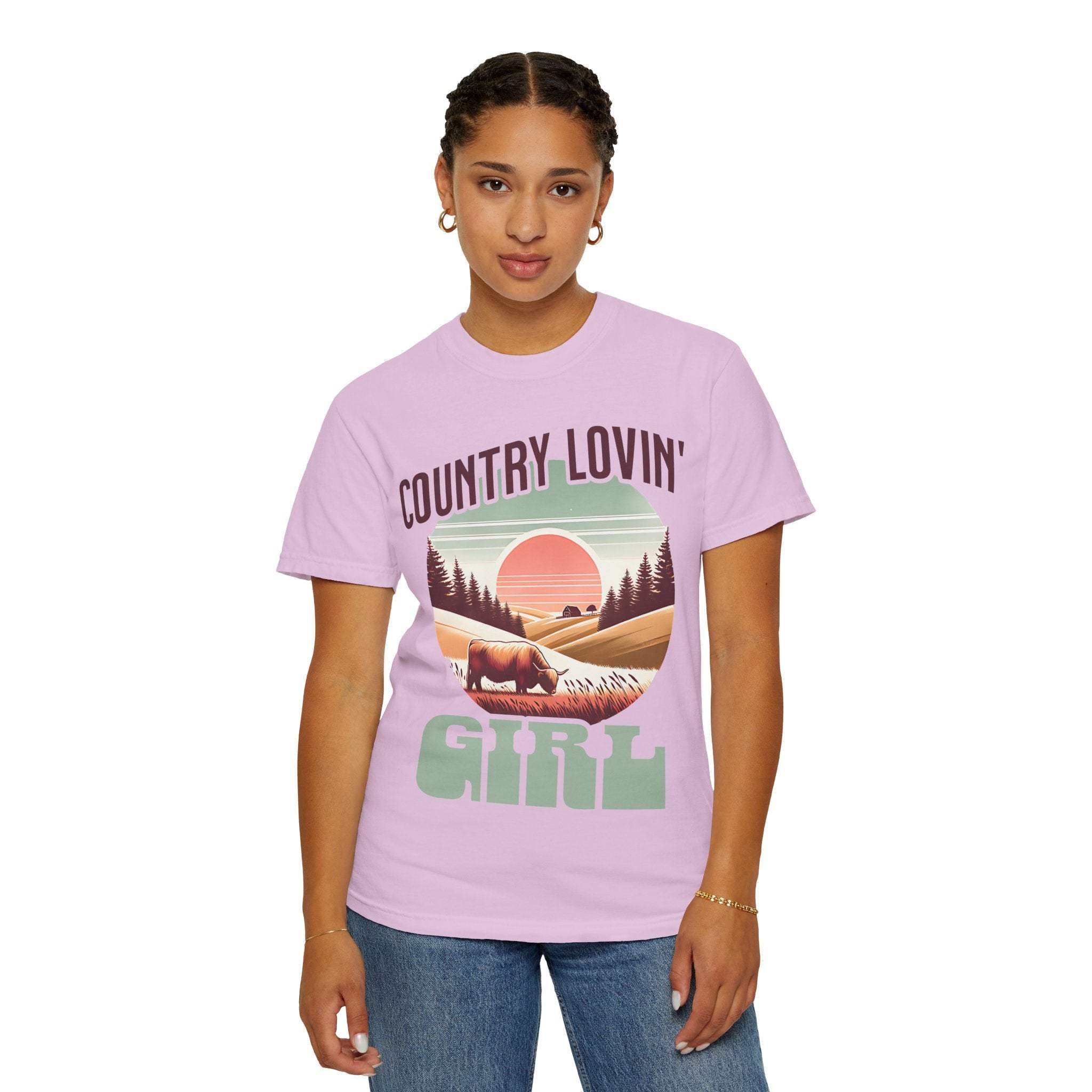 Woman wearing a vintage style Country Lovin Girl T-shirt with country landscape design in lavender color