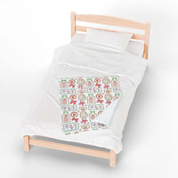 Velveteen Plush Blanket with retro Christmas frames on a bed
