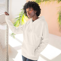 Woman wearing white fleece hoodie with kangaroo pocket indoors near window