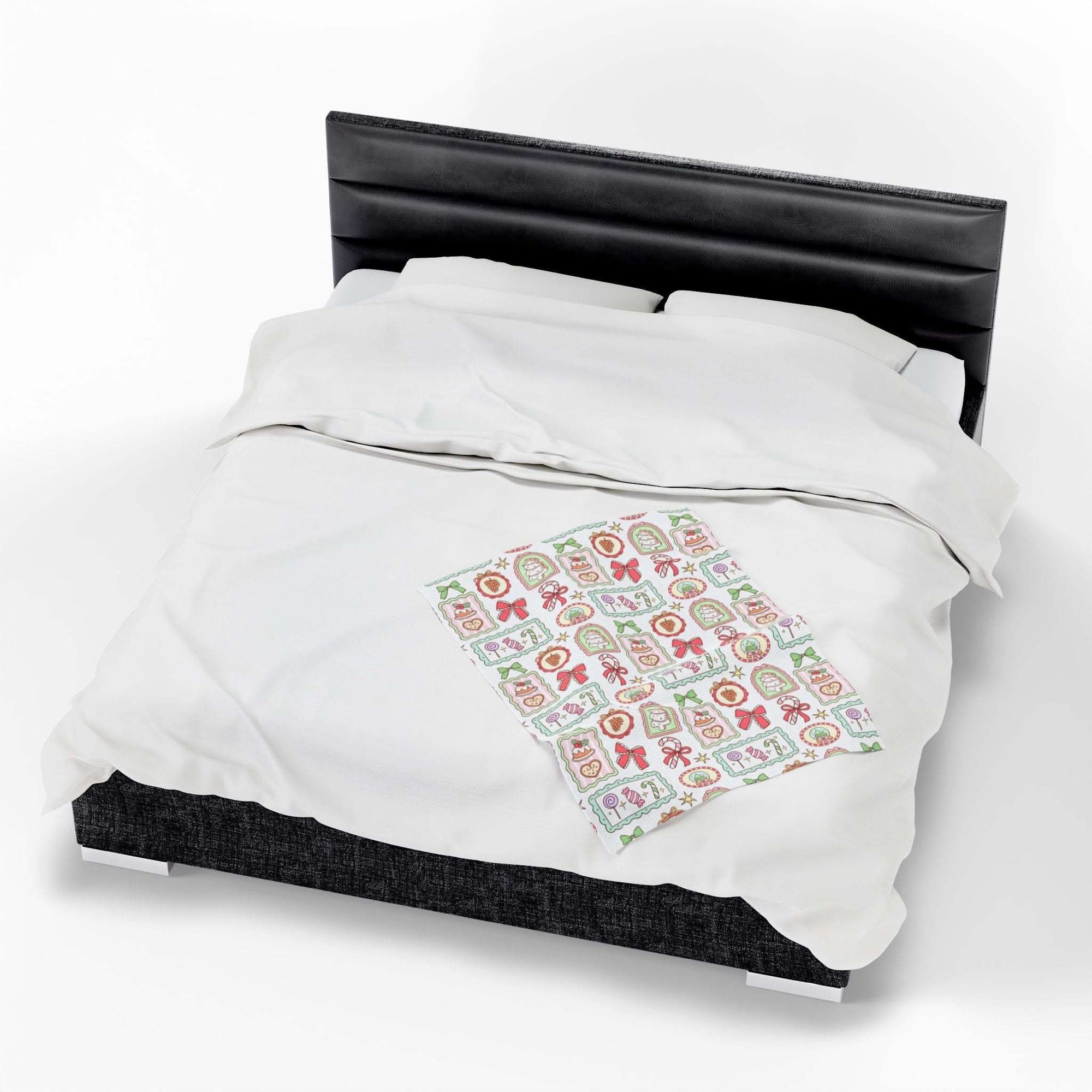 Velveteen plush blanket with retro Christmas frames design on a bed for cozy holiday decor