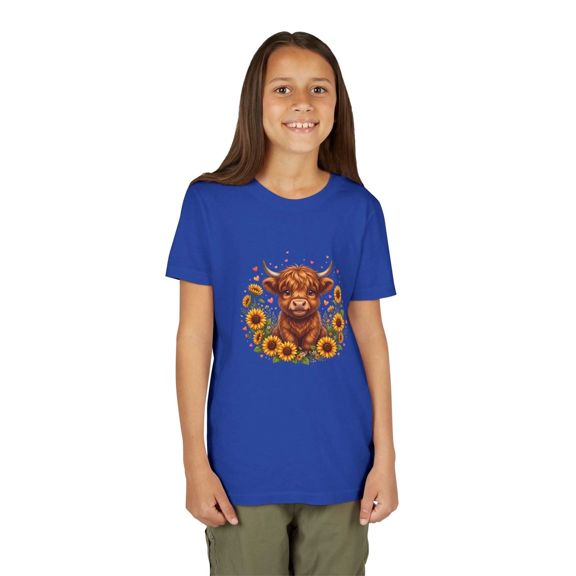 Youth tee featuring a Highland cow surrounded by bright sunflowers on a soft cotton shirt