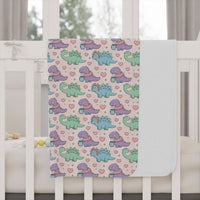 Toddler blanket with pastel dinosaurs wearing scarves, soft and cozy for naptime