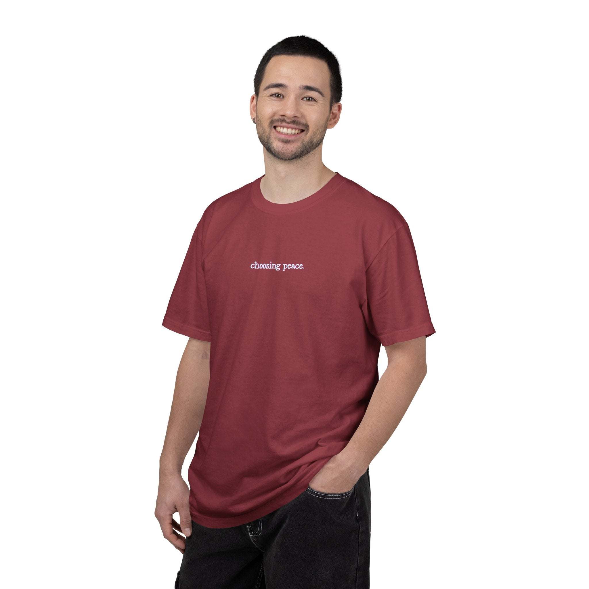 Man wearing a maroon t-shirt with text on a white background