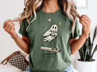 Model wearing a moss green mahjong T-shirt with a ghost holding a joker tile above a tile rack and “ghosted (he took the joker)” lettering.