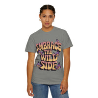Garment-dyed T-shirt with "Embrace the Wild Side" print and butterflies on gray fabric worn by woman