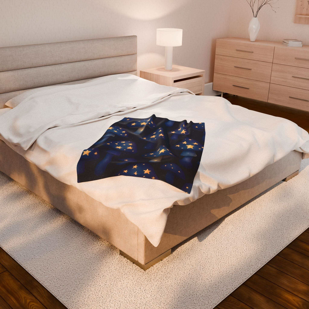 Velveteen plush blanket with whimsical mushrooms and glowing stars on bed in cozy bedroom